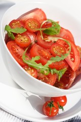 Close  - up of sliced tomatoes with rucola