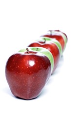 Close-up of apples in row on white background