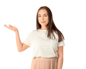 Portrait of beautiful woman showing something on white background