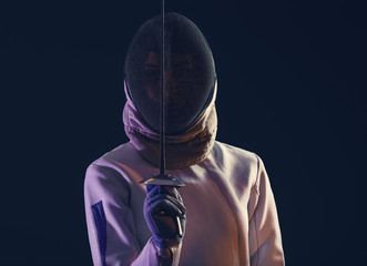 Young female fencer on dark background
