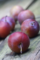 Plums on wooden table - close-up
