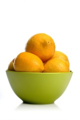 Studio shot of lemons in green bowl