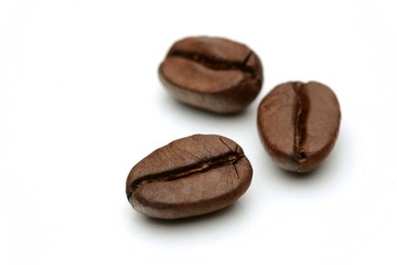Close-up of coffee grains on white background