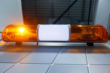 A working luminous emergency siren of orange-yellow color