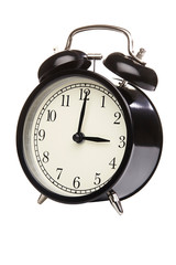 Black alarm clock isolated on white. Close up.