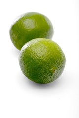 Limes on white background - close-up