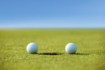 Golf balls near hole