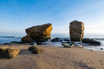 Fototapeta na wymiar Lanscape of sea cost in sunny day and big rocks 