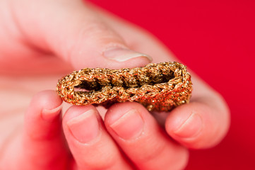 Dining napkin with gold napkin ring on red background