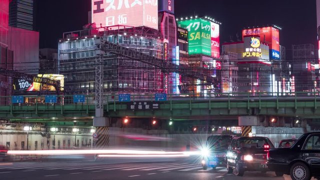 Car traffic and train transport at Kabukicho district in Shinjuku, Tokyo night cityscape medium shot. Asian city life, 4K time lapse.
