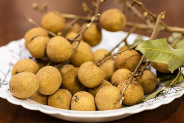 A bunch of longan in a white plate