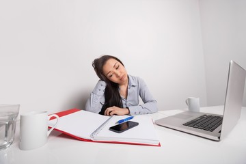 Bored businesswoman working at office desk