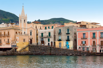Fototapeta na wymiar San Giuseppe church and multicolored houses in Lipari port, Aeolian islands, Italy