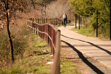 A man is riding a bike in uncrowded road in the nature healthy lifestyle