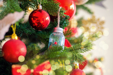 Christmas tree decoration. Red balls on a tree branch large.