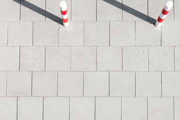 High angle view of striped poles on sidewalk