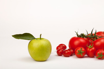 tomato and apples with leaves isolated on white background