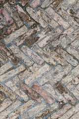Old brick floor made of bricks of different sizes in the antique Italian city of Antica Ostia