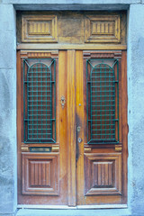 wooden door with a beautiful decorative metal bars in the historical part of the Italian capital