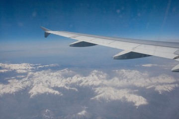 Fototapeta na wymiar Aerial view of snow covered alps through airplane; France