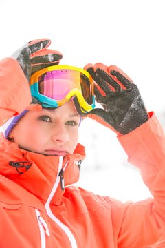 Confident young woman wearing ski goggles outdoors
