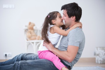 Side view of father and daughter spending quality time at home