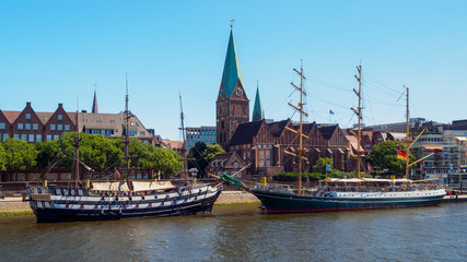 Alexander von Humboldt tall ship and others wooden sailing ships on River Weser. St. Martini church on background, Bremen, Germany - obrazy, fototapety, plakaty