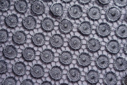 Delicate silver gray lace with circular pattern from above