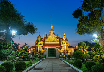 Wat Arun Famous Temple at sunset in bangkok Thailand. Giants front of the church at Wat Arun. Wat Arun is a Famous Buddhist temple in Bangkok Yai district of Bangkok, Thailand