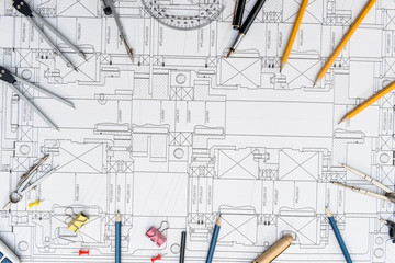 Paper with technical drawings and work tool on table. place of work.