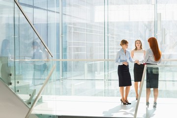 Full-length of businesswomen shaking hands in office