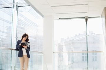 Fototapeta premium Businesswoman reviewing documents in office