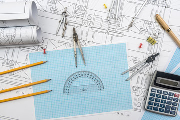 Technical drawing, graph paper and tools. Engineer  office team working with blueprints
