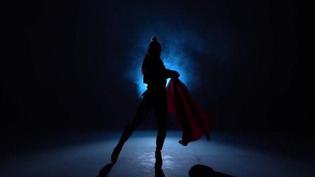 Torero in blue and gold suit or typical spanish bullfighter silhouette on a blue background of smoke