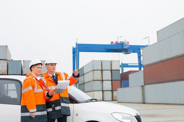 Workers examining cargo in shipping yard