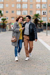 Happy couple walking together in the city