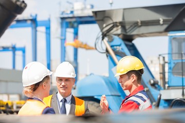 Workers discussing in shipping yard