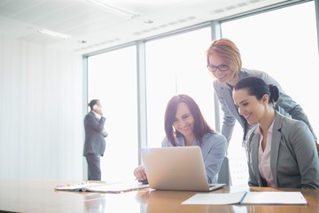 Businesswomen using laptop in office