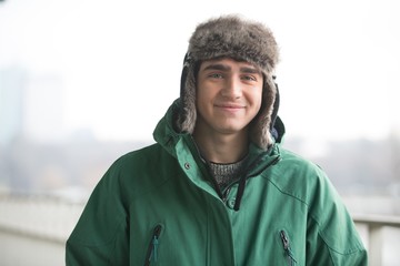 Portrait of man in winter wear smiling outdoors