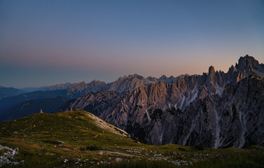 Panoramic view of famous Dolomites mountain peaks glowing in beautiful golden evening light at sunset in summer, South Tyrol, Italy