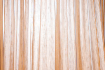 Beautiful beige curtain with mantinal lighting. Copy space.