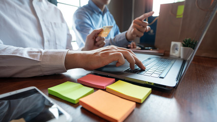 Man paying with credit card and entering security code for online shopping making a payment or purchasing goods on the internet with laptop computer, online shopping concept