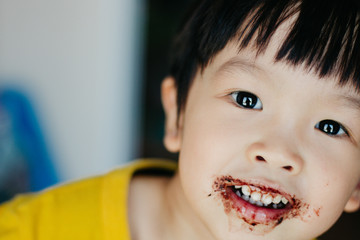 happy kids with face covered in chocolate