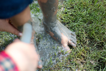 Washing dirty feet with water