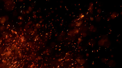 Burning red hot sparks fly from large fire in the night sky. Beautiful abstract background on the theme of fire, light and life. Burning embers glowing flying away particles over black background.