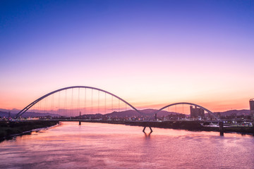Crescent Bridge - landmark of New Taipei, Taiwan with beautiful illumination at day, aerial photography in New Taipei, Taiwan.