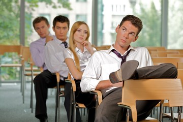 Business executives sitting in row at office