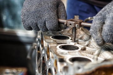 Mechanic using Taps and Dies tool making Internal and External  Threads nut in engine camshaft cap...
