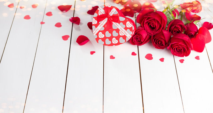 Heart shape gift packages and roses on white wooden table. Backgrounds for special days ( Valentine's Day, Wedding anniversary, birthday and dating, Christmas, New Year )
