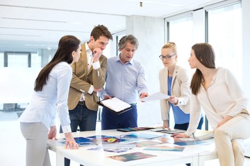 Mature businessman with team working on new project at office